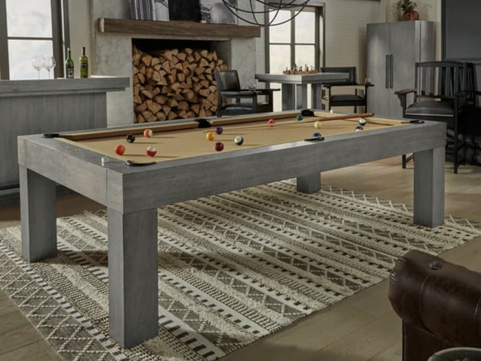 Streamlined pool table in gray wood with tan cloth and straight square legs in a lodge-style game room