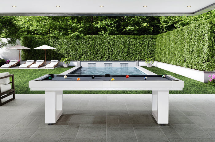 White outdoor pool table with gray cloth on a covered patio beside a backyard pool